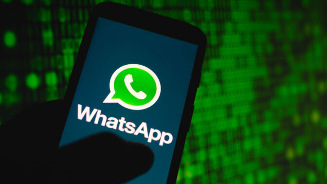 In this photo illustration the WhatsApp logo seen displayed on a smartphone. 