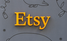 The Etsy logo in orange on a grey background.