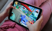 Child playing a racing game on iPad mini 5