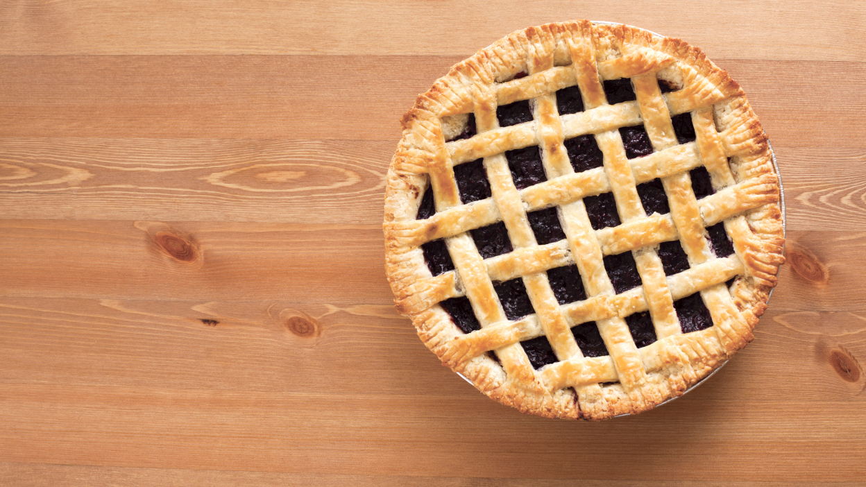 A freshly baked pie on a wooden countertop.