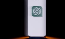 A phone displays a green OpenAI logo.