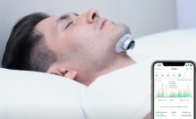 Person sleeping with the Snore Circle Electronic Muscle Stimulator.