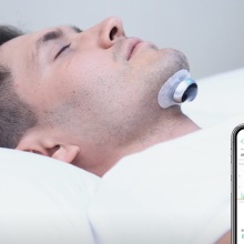 Person sleeping with the Snore Circle Electronic Muscle Stimulator.