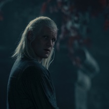 Daemon Targaryen stands beneath a weirwood tree at night.