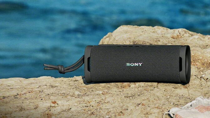 Sony ULT Field 1 speaker sits on a rock near the water