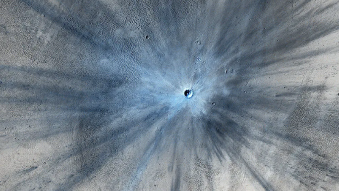 NASA's Mars Reconnaissance Orbiter captured an image of a fresh impact crater on Mars in 2013.