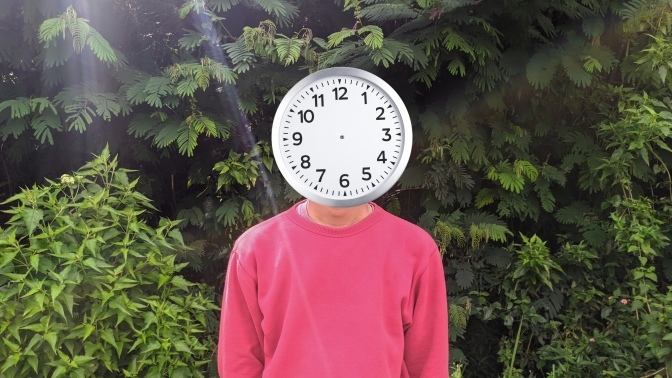 Person with a clock for a head in the woods