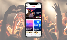 A composite image of a stock music festival photo behind a phone showing Tinder's Festival Mode.