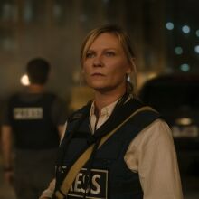 A woman in a bulletproof vest that reads "press."