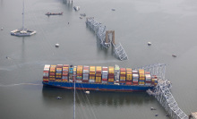 Cargo ship pictured from above, the Key Bridge collapsed into water.