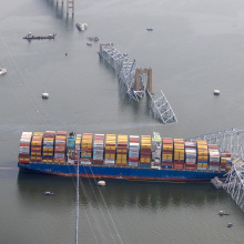 Cargo ship pictured from above, the Key Bridge collapsed into water.