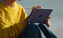 A kid uses the Apple iPad Mini