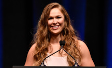 ronda rousey standing at a lectern