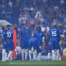 Players of Chelsea prepare to enter a huddle