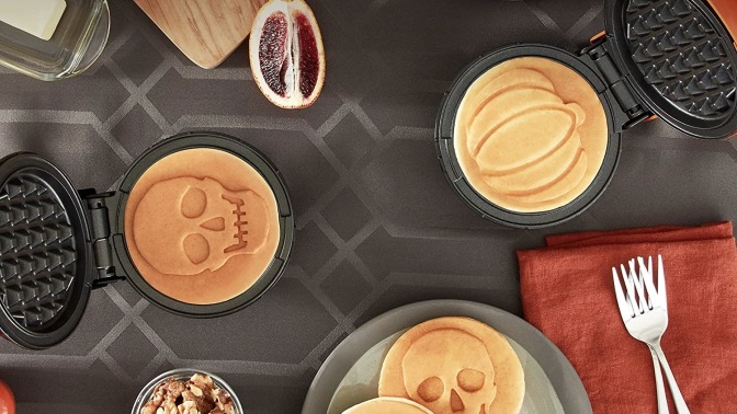 halloween dash waffle makers with skull and pumpkin waffles on a black and orange table setting