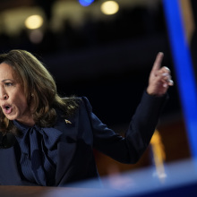 Kamala Harris speaking enthusiastically at the DNC podium.