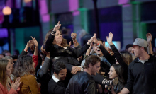 Melissa McCarthy crowd-surfs to pick up her MTV Movie Award, like the badass she is