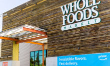 Image of Whole Foods store with Amazon banner in front