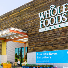 Image of Whole Foods store with Amazon banner in front