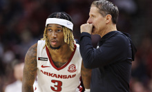 Arkansas head coach Eric Musselman talks on the court with El Ellis of the Arkansas Razorbacks during the game against the Texas A&M Aggies at Bud Walton Arena on January 16, 2024, in Fayetteville, Arkansas.