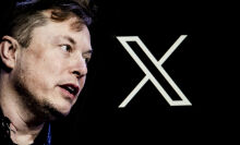 Elon Musk's photo is displayed on a phone screen in front of a computer screen displaying. the Twitter/X logo.