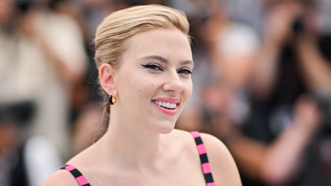 Scarlett Johansson smiles directly at the camera.