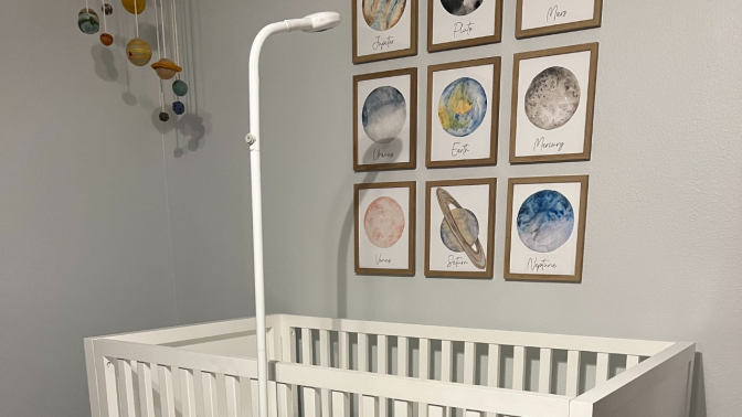 tall scope-like baby monitor looking over crib