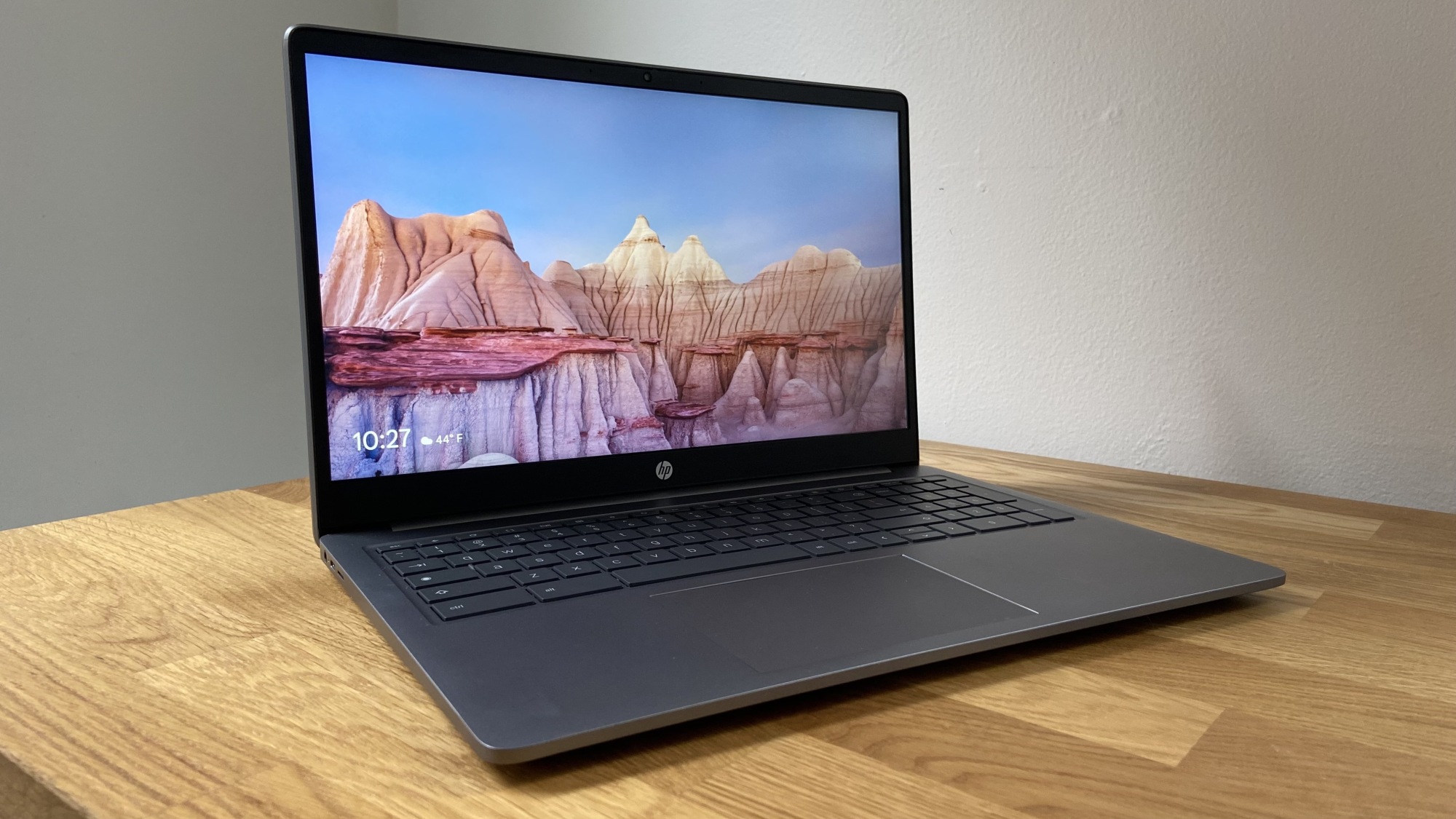 an angled view of the hp chromebook plus 15.6-inch on a wooden table