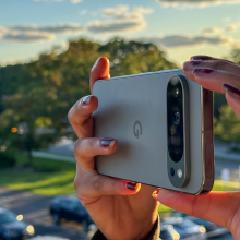 The Pixel 9 Pro XL being held horizonally as someone appears to take a photograph.