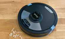 shark ai ultra 2 in 1 robot vacuum on hardwood floor approaching cheerios