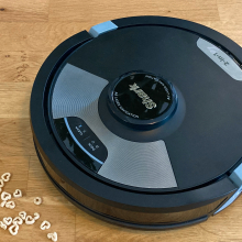 shark ai ultra 2 in 1 robot vacuum on hardwood floor approaching cheerios