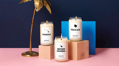 three lit homesick candles