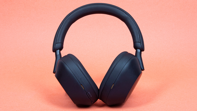 black sony headphones on orange background