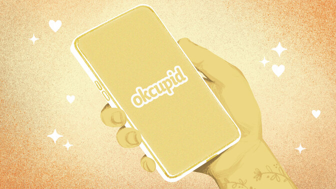 A drawn hand holding a phone with the okcupid logo 