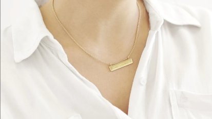 person wearing gold plate necklace