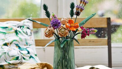 lego bouquet in a green vase on a table