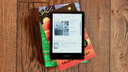 kindle paperwhite signature edition on pile of books