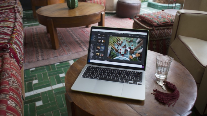 MacBook laptop sitting on a coffee table in a living room