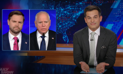 A man in a suit sits behind a talk show desk. In the top-left is a side-by-side image of two other men in suits.