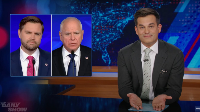 A man in a suit sits behind a talk show desk. In the top-left is a side-by-side image of two other men in suits.