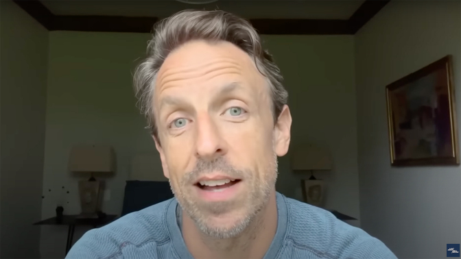 A man sits in a room talking to the camera.