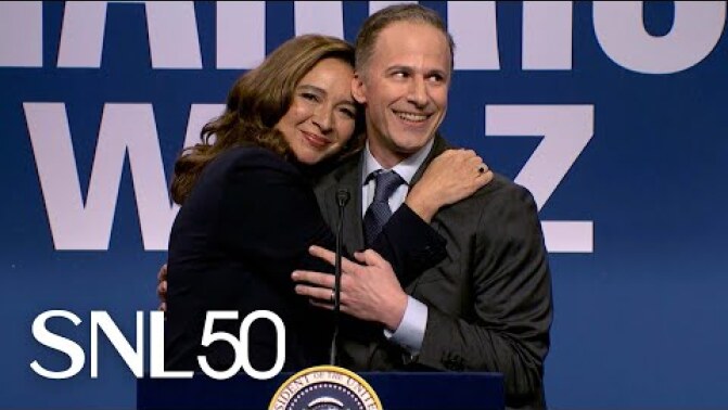 Maya Rudolph as Kamala Harris embracing Andy Samberg as Doug Emhoff at a podium in the 'SNL' cold open