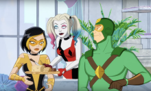 A screenshot from 'Kite Man: Hell Yeah!' showing Harley Quinn offering a cheese plate to Golden Glider as Kite Man sits beside her.