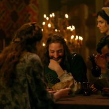 In "The Decameron" a group of nobles giggle at a dinner table.