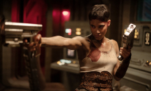 Sofia Boutella holds a gun ready for battle in "Rebel Moon".