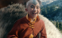 A screenshot from the final trailer of the live action "Avatar: The Last Airbender." Aang is smiling as he rides his sky bison.