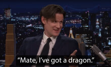 A man sits in a talk show chair, pointing and grinning. The caption at the bottom reads, "Mate, I've got a dragon."