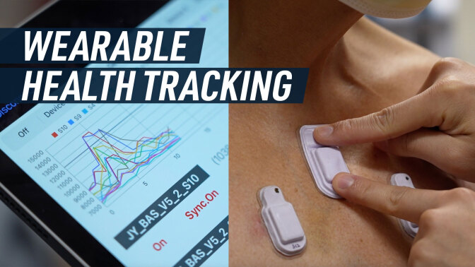 A split screen shows some graphs on a tablet (left), and tiny wearables devices attached to a patient's skin (right). Caption reads: "Wearable health tracking"