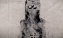 A sketch shows a man wearing a dark hooded outfit.