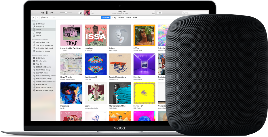 En MacBook med iTunes på skærmen og en HomePod ved siden af.